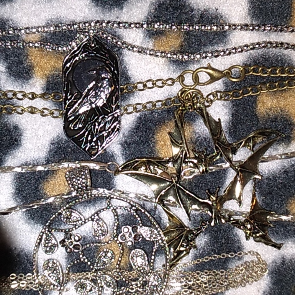 All silver and one brass necklaces